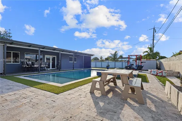 a view of a swimming pool with chairs in patio