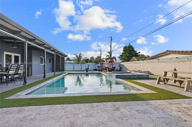 a view of swimming pool with outdoor seating