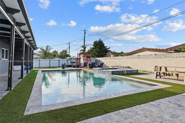 a view of swimming pool with outdoor seating