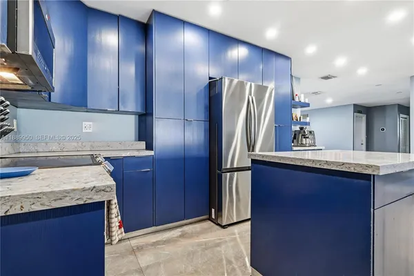 a kitchen with stainless steel appliances granite countertop wooden cabinets a sink and a large window