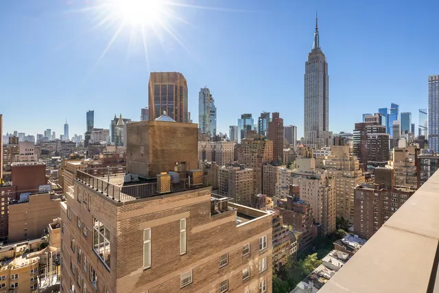 a living room with furniture a flat screen tv and a large window