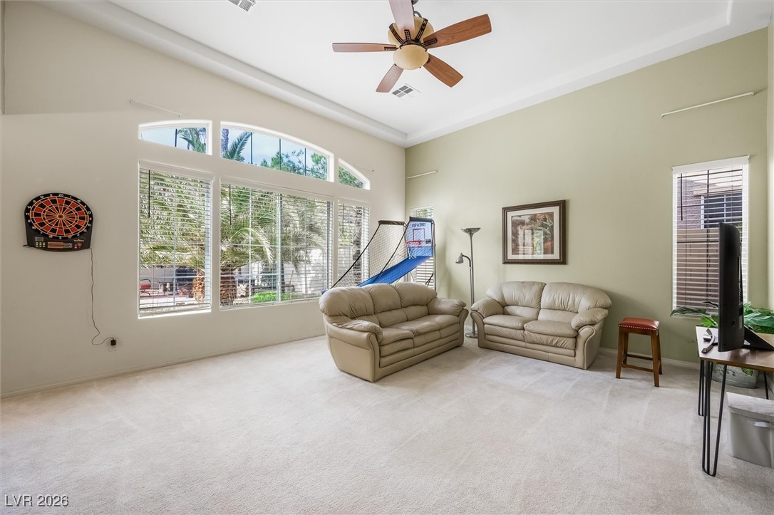 7517 Midnight Rambler Street Las Vegas, NV 89149 - Photo 14 of 68 LARGE living room with high coffered ceilings and windows facing the beautiful backyard