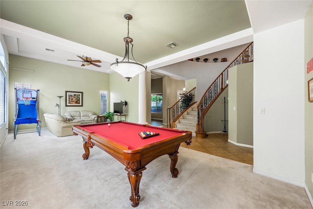 7517 Midnight Rambler Street Las Vegas, NV 89149 - Photo 20 of 68 Another view of dining room/game room facing the living room and winding staircase to the 2nd level and a peek a boo view into the den/study or whatever you want to make it. Could be a 5th bedroom.