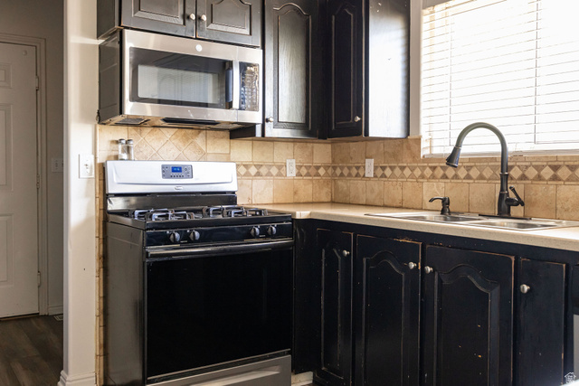 892 East 400 South Smithfield, UT 84335 - Photo 11 of 44 Kitchen with gas stove, light countertops, stainless steel microwave, and decorative backsplash
