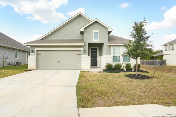 a view of a house with a yard and garage