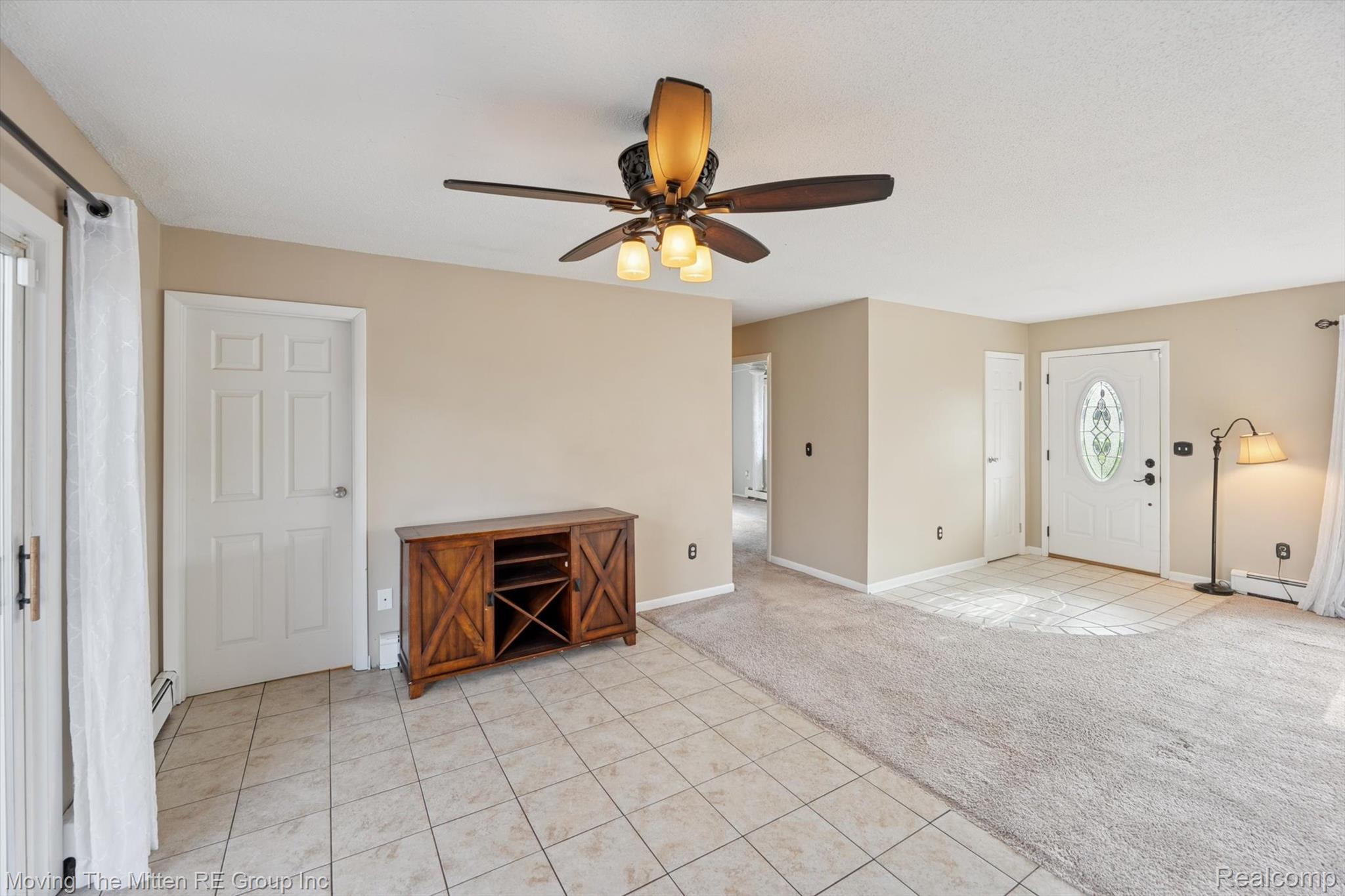12000 Plank Road Milan, MI 48160 - Photo 15 of 49 Entrance foyer with light tile patterned flooring, light colored carpet, ceiling fan, a baseboard radiator, and a baseboard heating unit