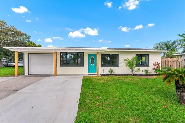a front view of a house with patio and garden
