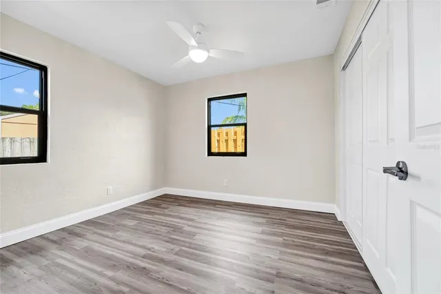 wooden floor in an empty room with a window