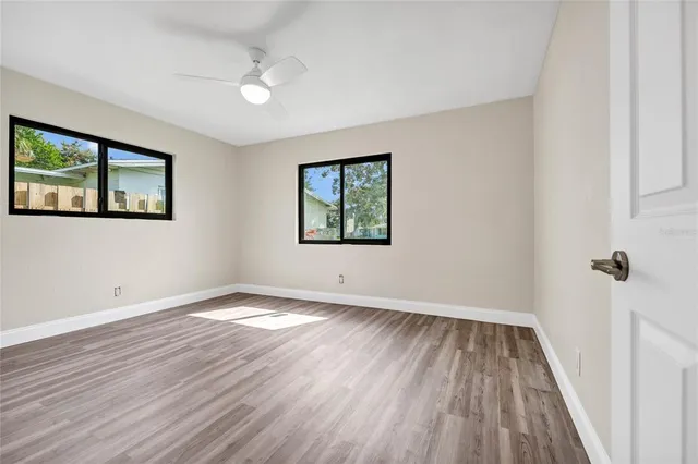 wooden floor in an empty room with a window