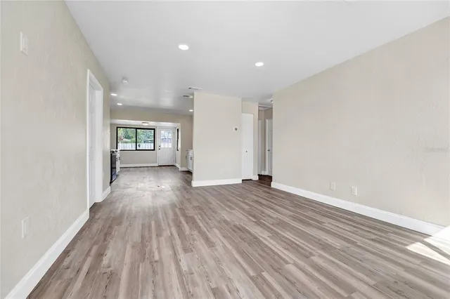 wooden floor in an empty room with a window