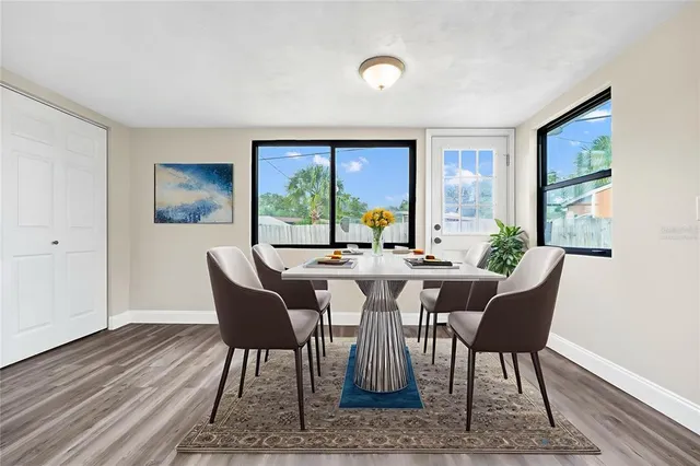 a view of a dining room with furniture window and wooden floor