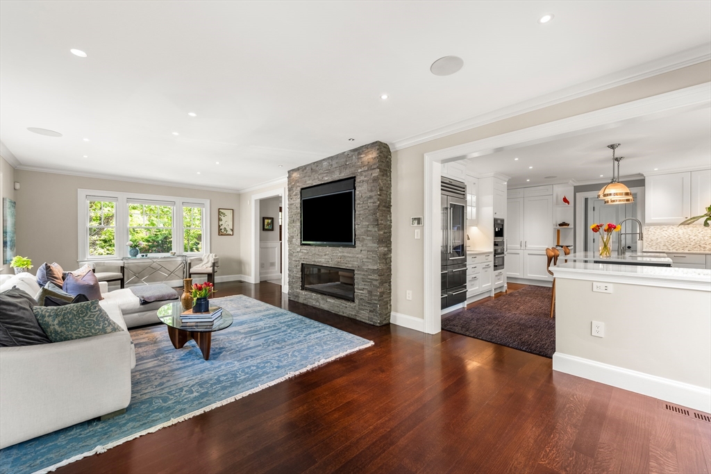 53 Crowninshield Road Brookline, MA 02446 - Photo 14 of 42 a living room with fireplace furniture and a flat screen tv