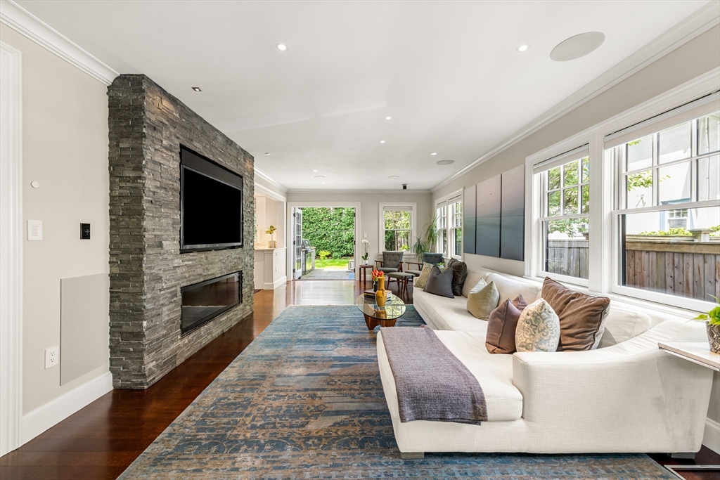 53 Crowninshield Road Brookline, MA 02446 - Photo 15 of 42 a living room with fireplace furniture and a flat screen tv