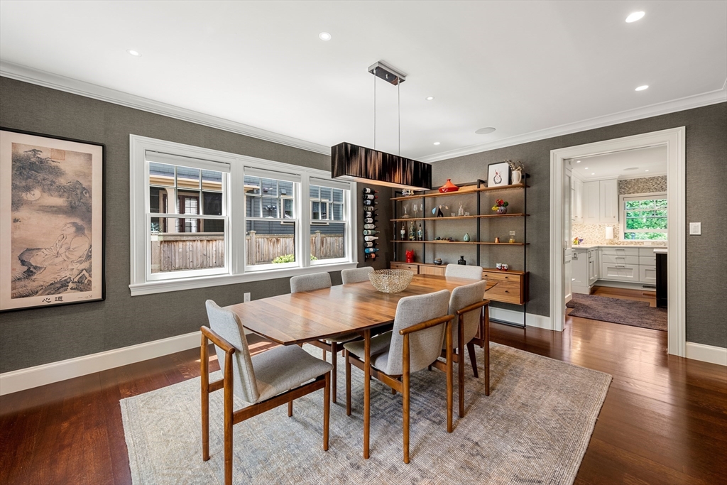 53 Crowninshield Road Brookline, MA 02446 - Photo 19 of 42 a dining room with furniture and wooden floor