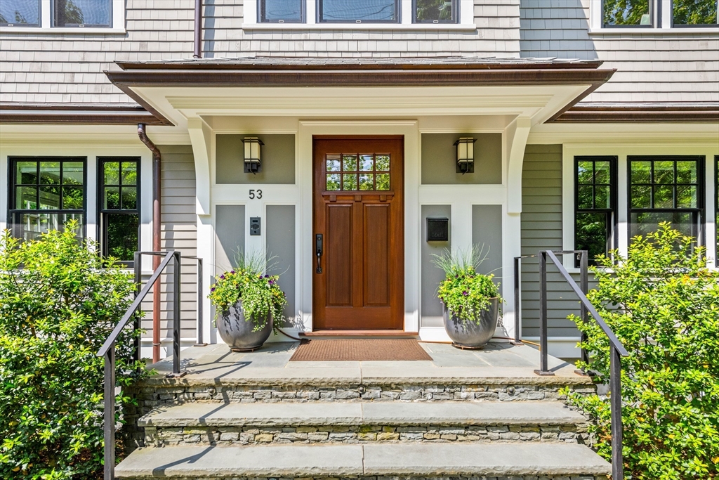53 Crowninshield Road Brookline, MA 02446 - Photo 2 of 42 a front view of a house with potted plants