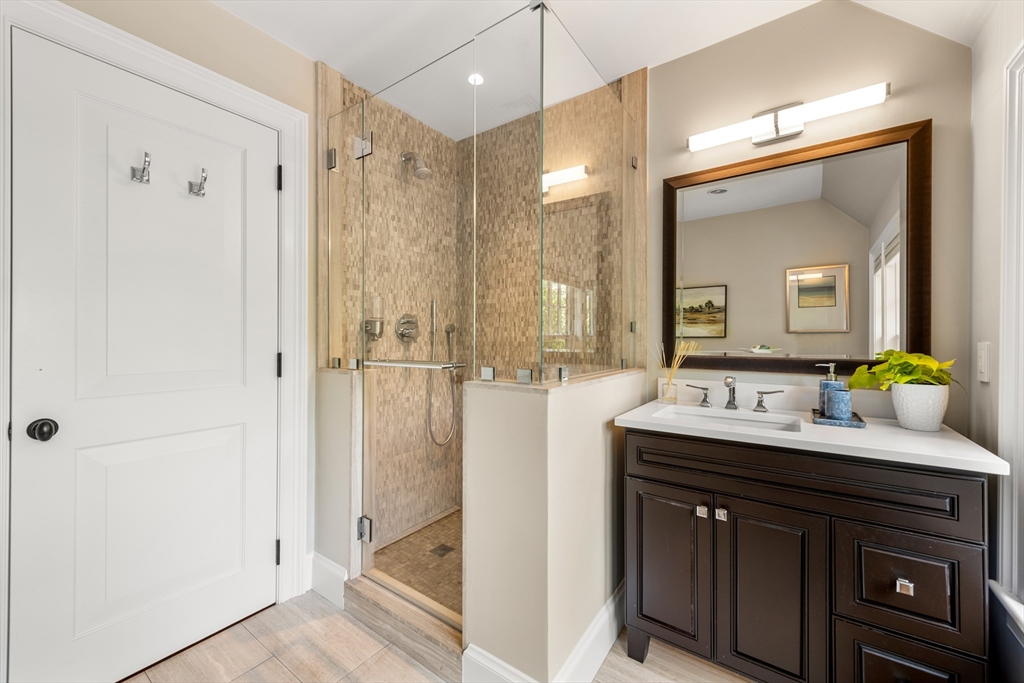 53 Crowninshield Road Brookline, MA 02446 - Photo 26 of 42 a bathroom with a double vanity sink mirror and shower