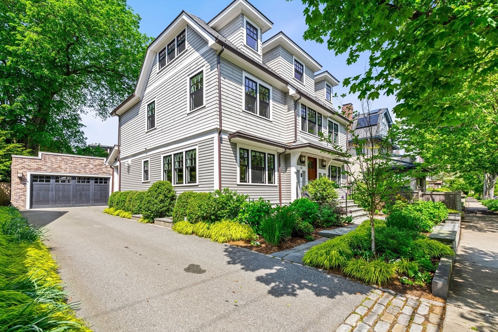 53 Crowninshield Road Brookline, MA 02446 - Photo 3 of 42 a front view of a house with a yard and trees