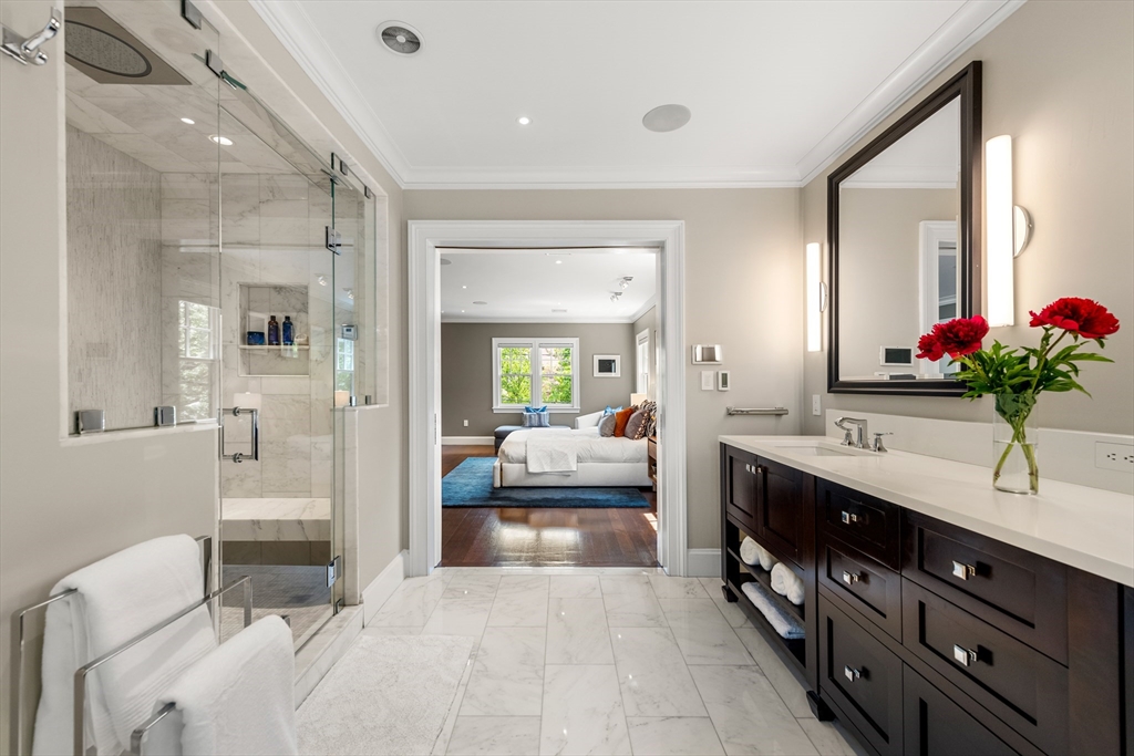 53 Crowninshield Road Brookline, MA 02446 - Photo 33 of 42 a en suite spacious bathroom with a granite countertop sink mirror and shower