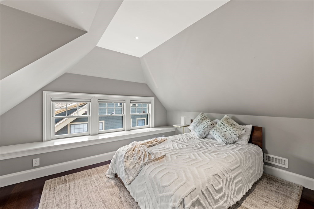 53 Crowninshield Road Brookline, MA 02446 - Photo 35 of 42 a bedroom with a large bed and a large window