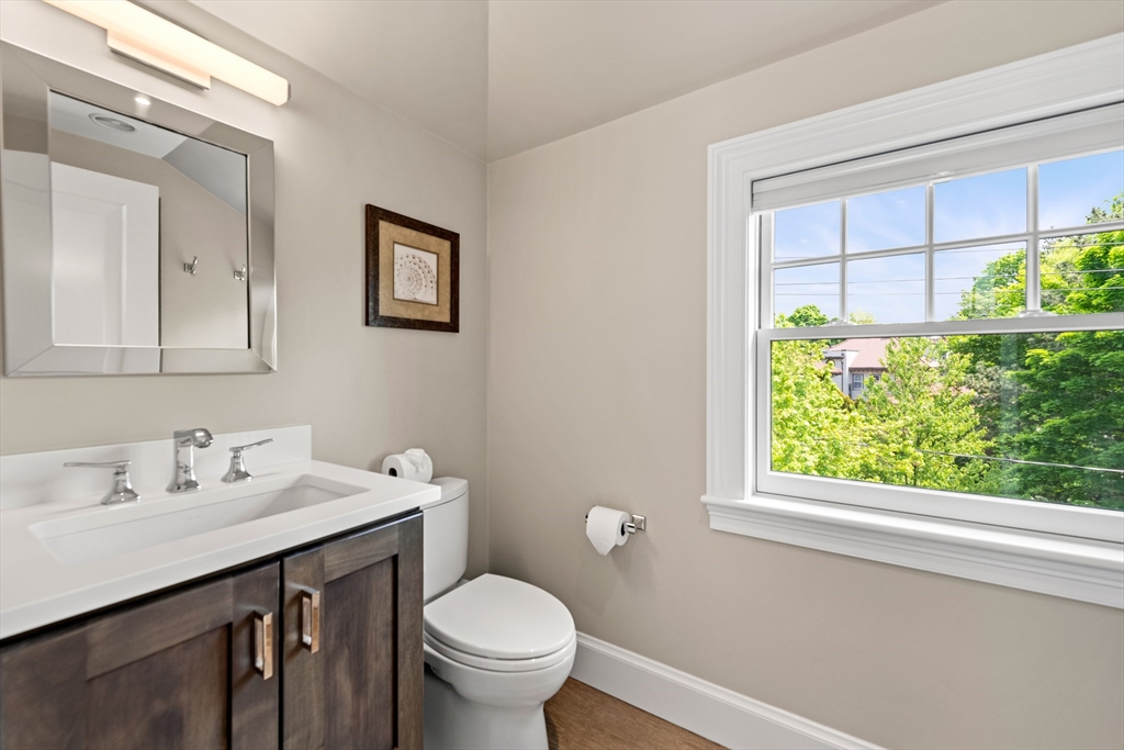 53 Crowninshield Road Brookline, MA 02446 - Photo 36 of 42 a bathroom with a sink a toilet and a window