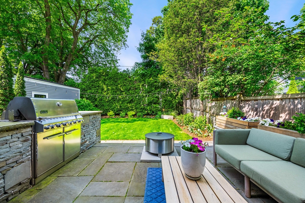 53 Crowninshield Road Brookline, MA 02446 - Photo 7 of 42 a view of a chairs and table in the back yard of the house