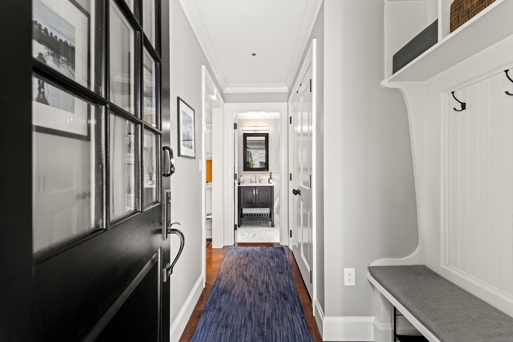 53 Crowninshield Road Brookline, MA 02446 - Photo 8 of 42 a view of hallway with wooden floor and stairs