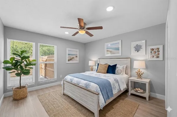 a bedroom with a bed potted plant with the window