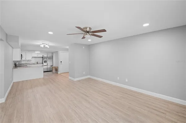 a view of an empty room with a kitchen