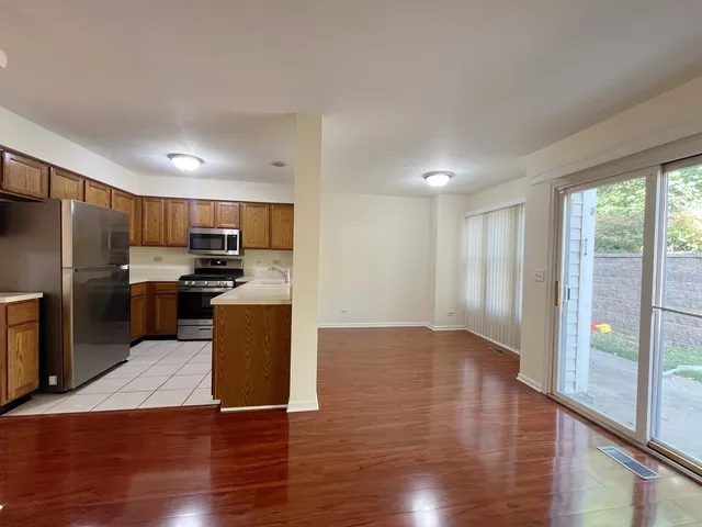 a kitchen with granite countertop stainless steel appliances and wooden cabinets