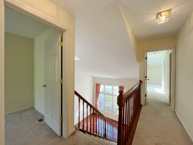 a view of a hallway with wooden floor and entryway