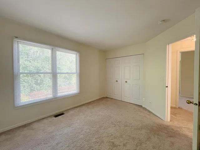 an empty room with a empty space and windows