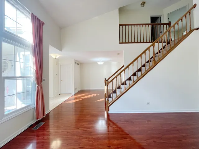 a view of staircase with wooden floor and a window