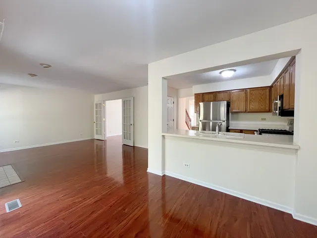 a view of kitchen with cabinets and wooden floor