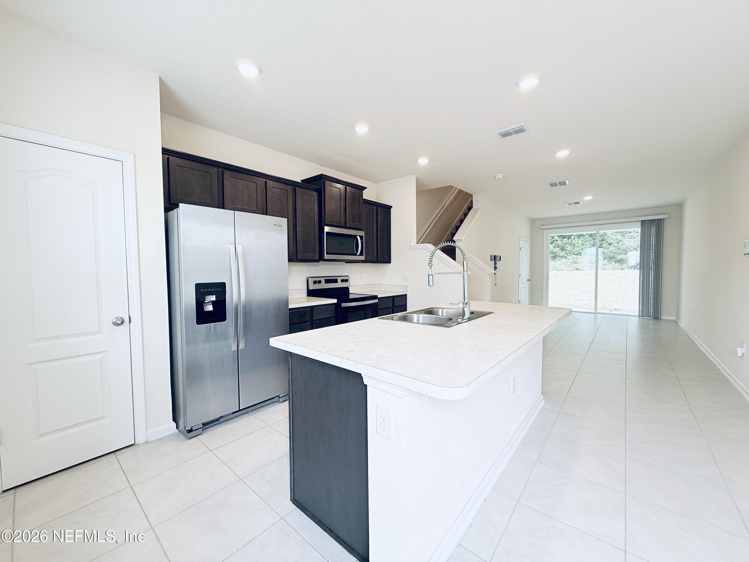 847 Gate Run Road Jacksonville, FL 32211 - Photo 2 of 19 a large kitchen with a refrigerator a sink dishwasher and a stove with wooden floor