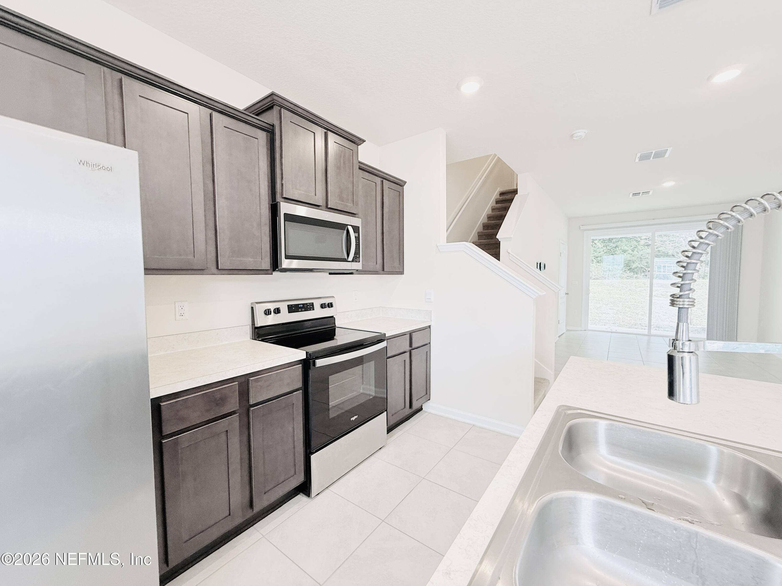 847 Gate Run Road Jacksonville, FL 32211 - Photo 3 of 19 a kitchen with stainless steel appliances a sink and a refrigerator
