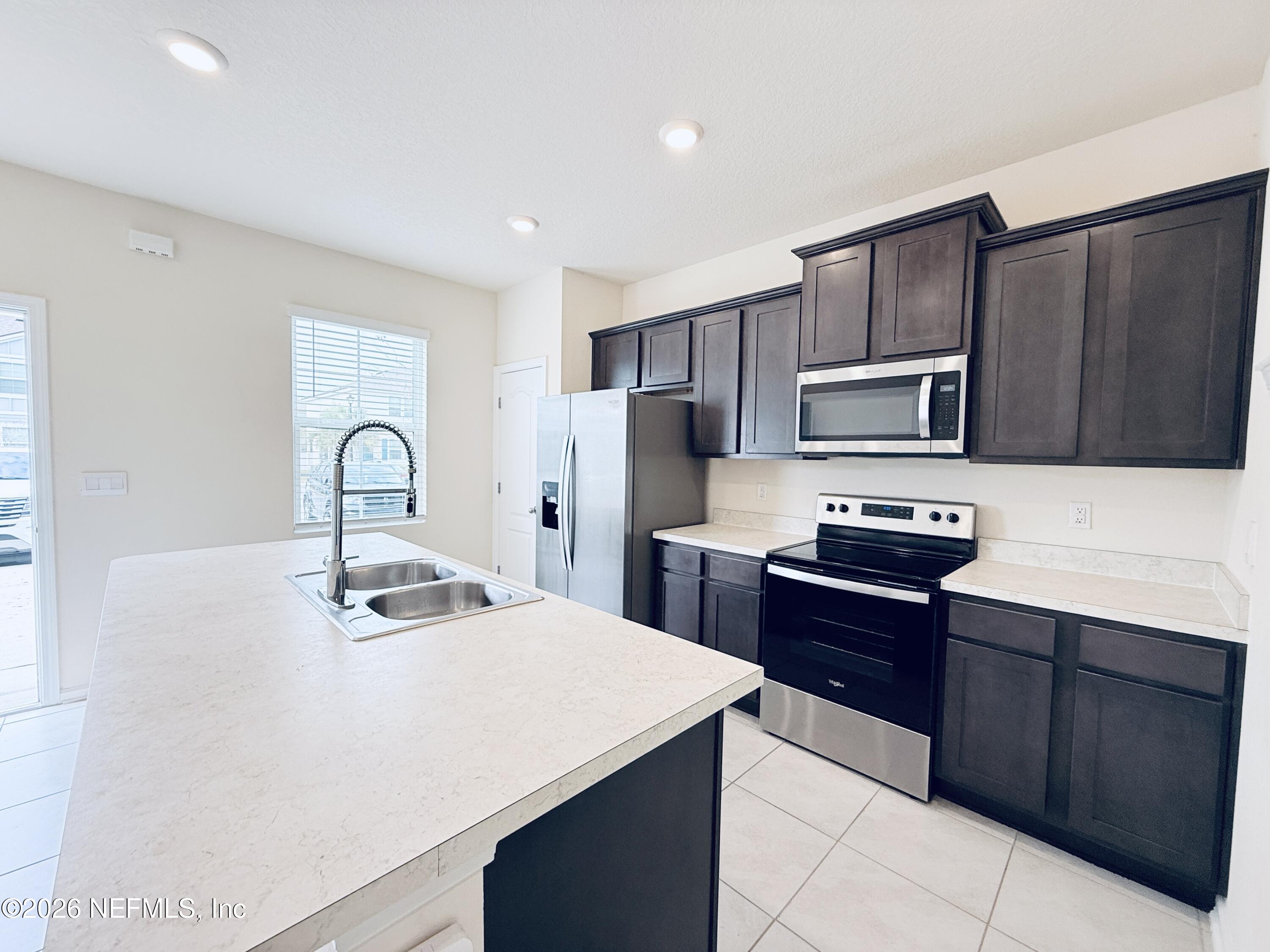 847 Gate Run Road Jacksonville, FL 32211 - Photo 4 of 19 a kitchen with kitchen island a sink appliances and cabinets