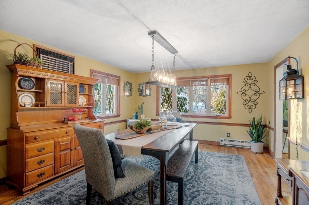 6 Oxford Road Hampstead, NH 03841 - Photo 11 of 32 a dining room with furniture a chandelier and wooden floor