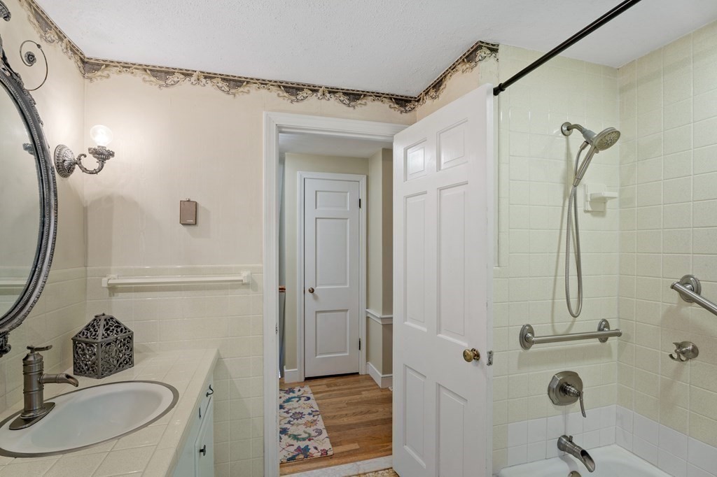 6 Oxford Road Hampstead, NH 03841 - Photo 17 of 32 a bathroom with a sink a toilet a mirror and shower
