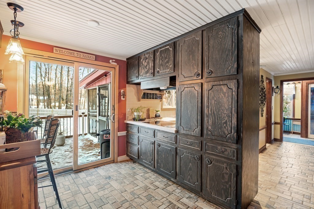 6 Oxford Road Hampstead, NH 03841 - Photo 7 of 32 a kitchen with stainless steel appliances granite countertop a refrigerator and wooden cabinets