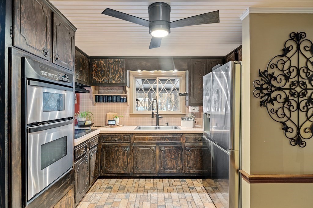 6 Oxford Road Hampstead, NH 03841 - Photo 9 of 32 a kitchen with stainless steel appliances a sink stove and refrigerator