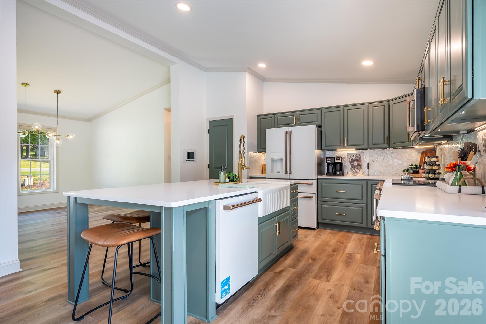 7858 Blackwood Road Denver, NC 28037 - Photo 6 of 11 a kitchen with stainless steel appliances granite countertop a refrigerator a stove top oven a sink dishwasher and white cabinets with wooden floor