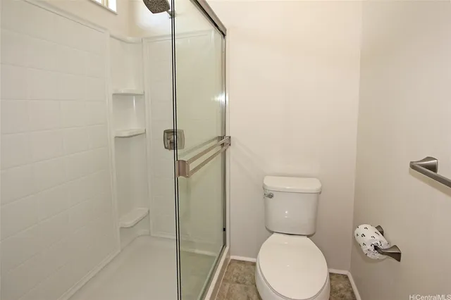 a bathroom with a toilet and a shower