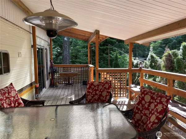 a view of balcony with wooden floor and outdoor seating