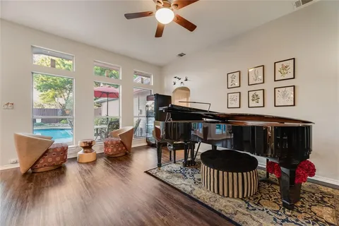 a living room with furniture and wooden floor