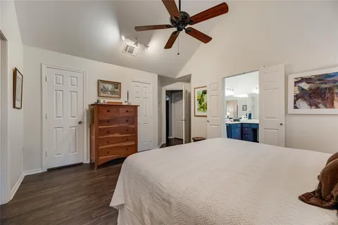a spacious bathroom with a granite countertop double vanity sink and a mirror