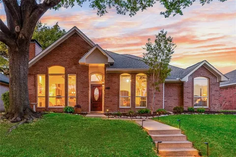 front view of brick house with a yard