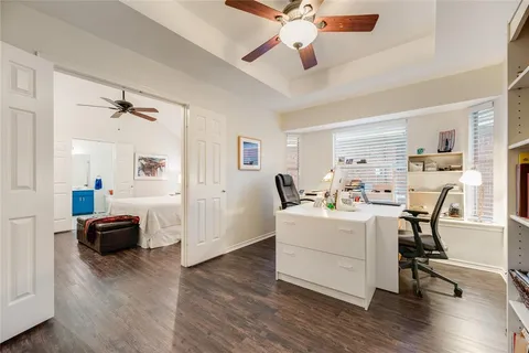a living room with furniture and a book shelf