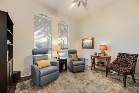 a bedroom with furniture and a flat screen tv