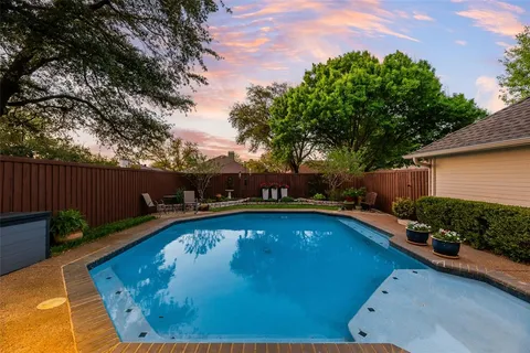 a view of a house with swimming pool and a chairs