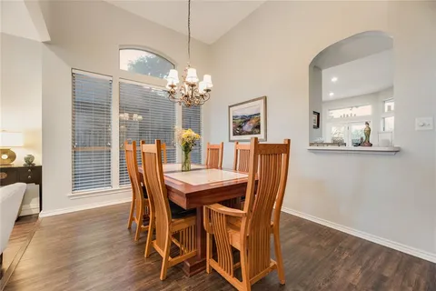a view of a dining room with furniture wooden floor and chandelier